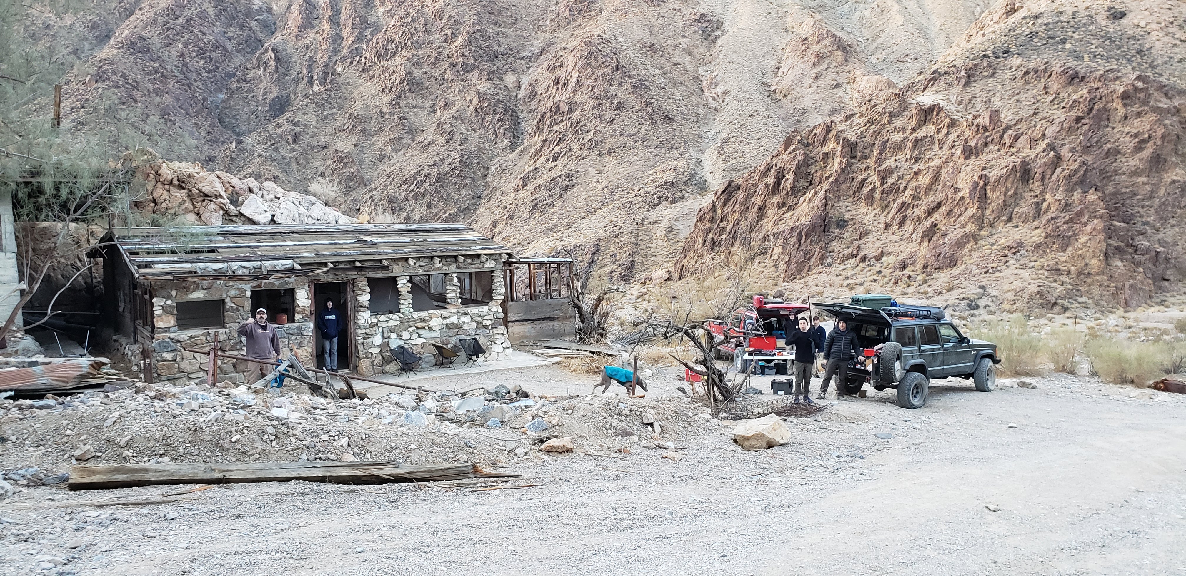 Blue Tacoma navigating a trail while wheels lift off the ground