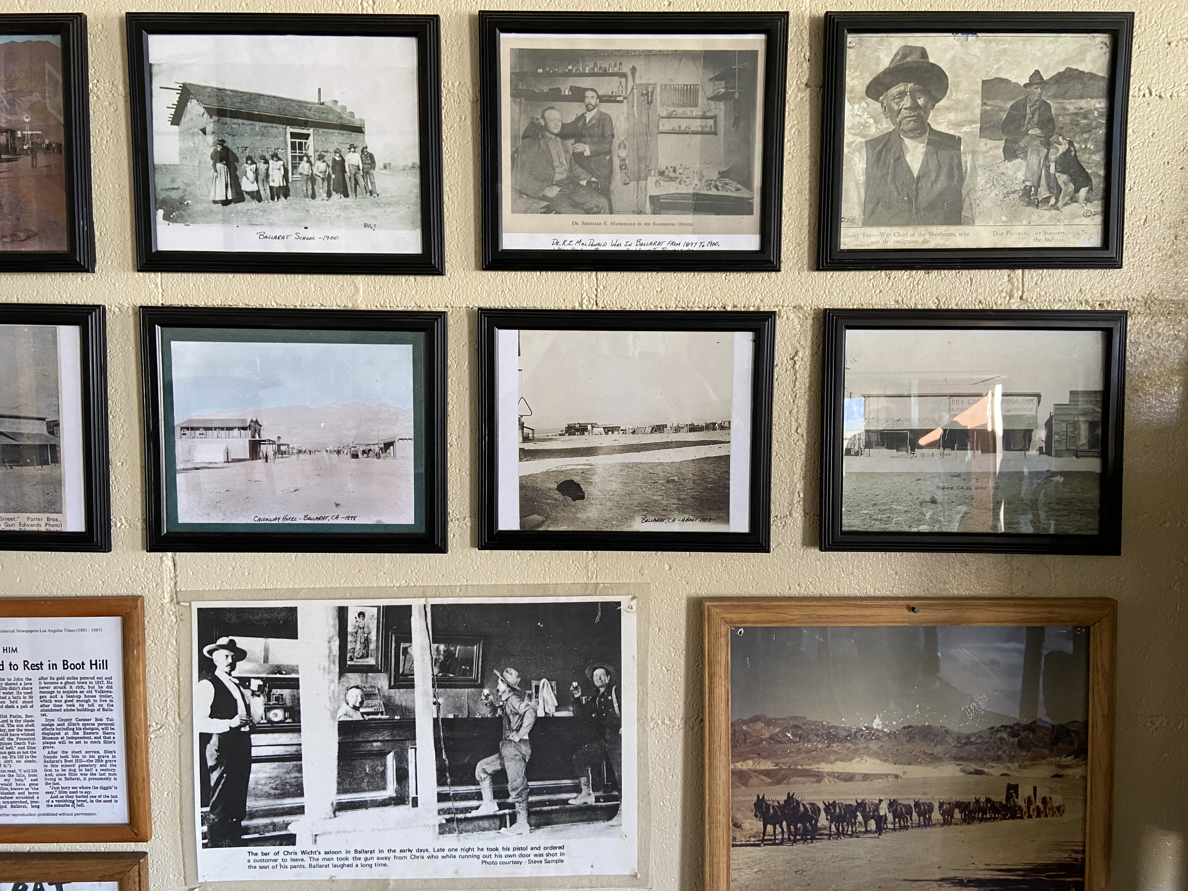 Flyers/photos/articles framed on a wall.