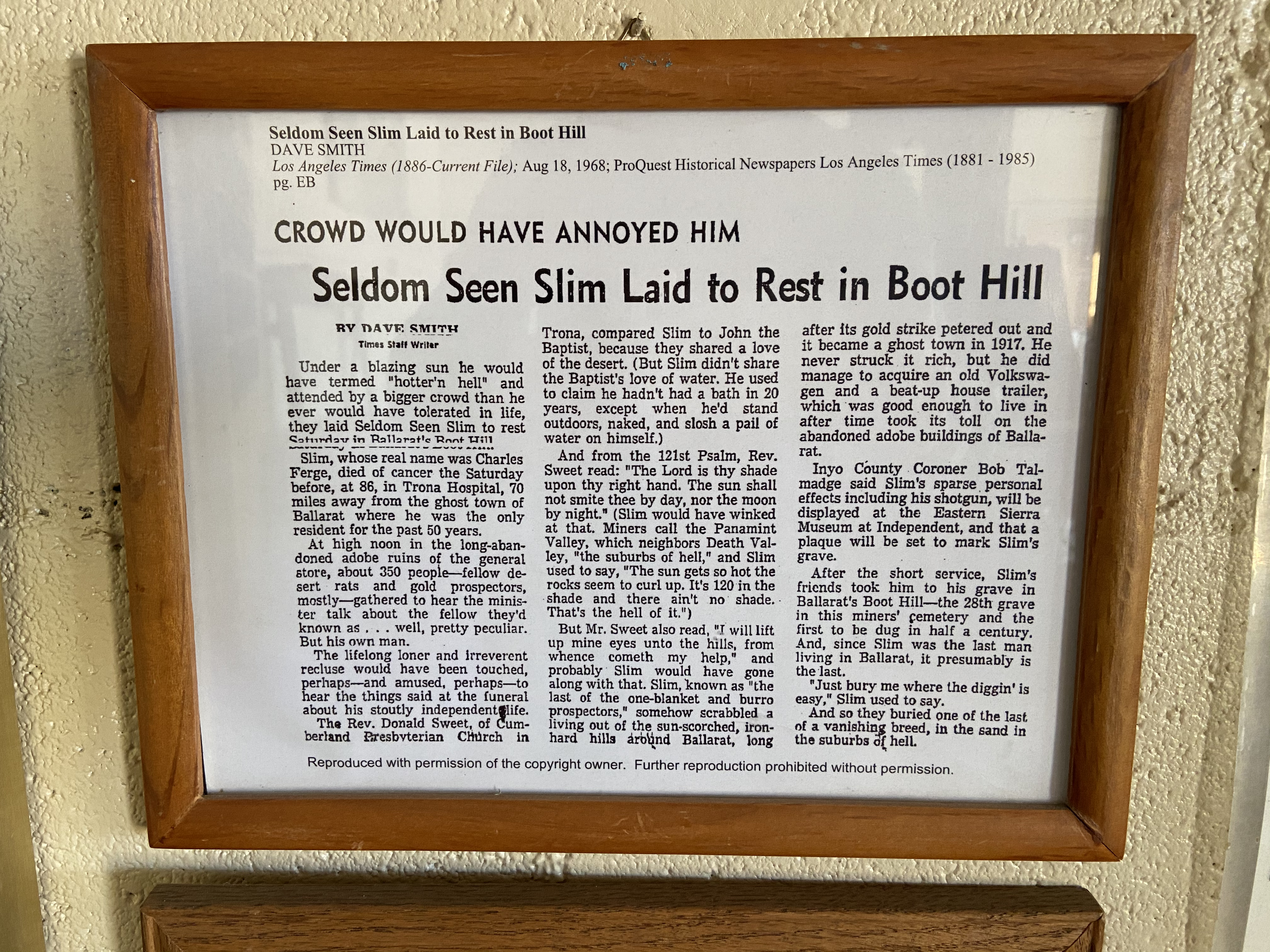 Flyers/photos/articles framed on a wall.