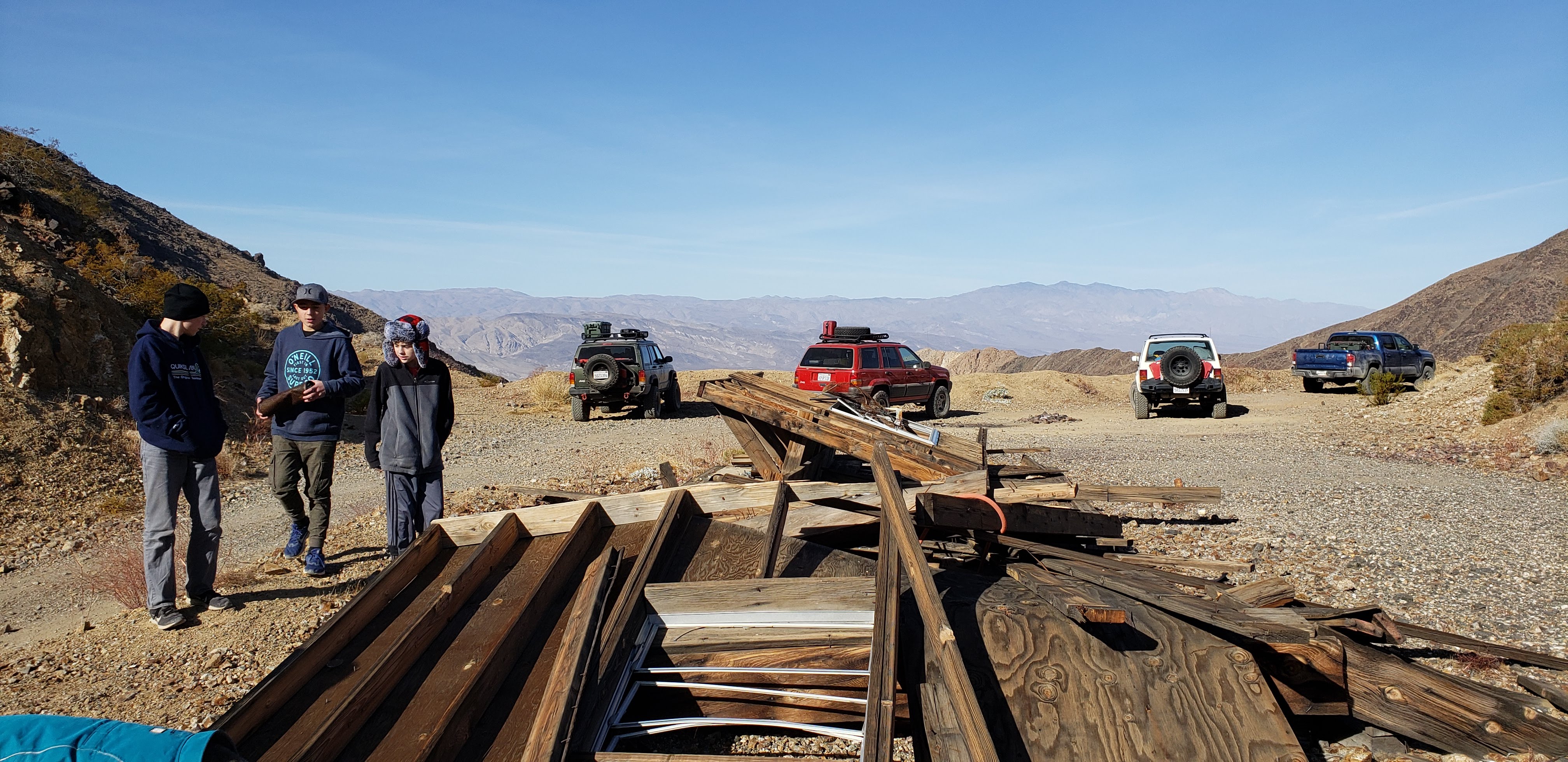 People, cars, and wooden debris.