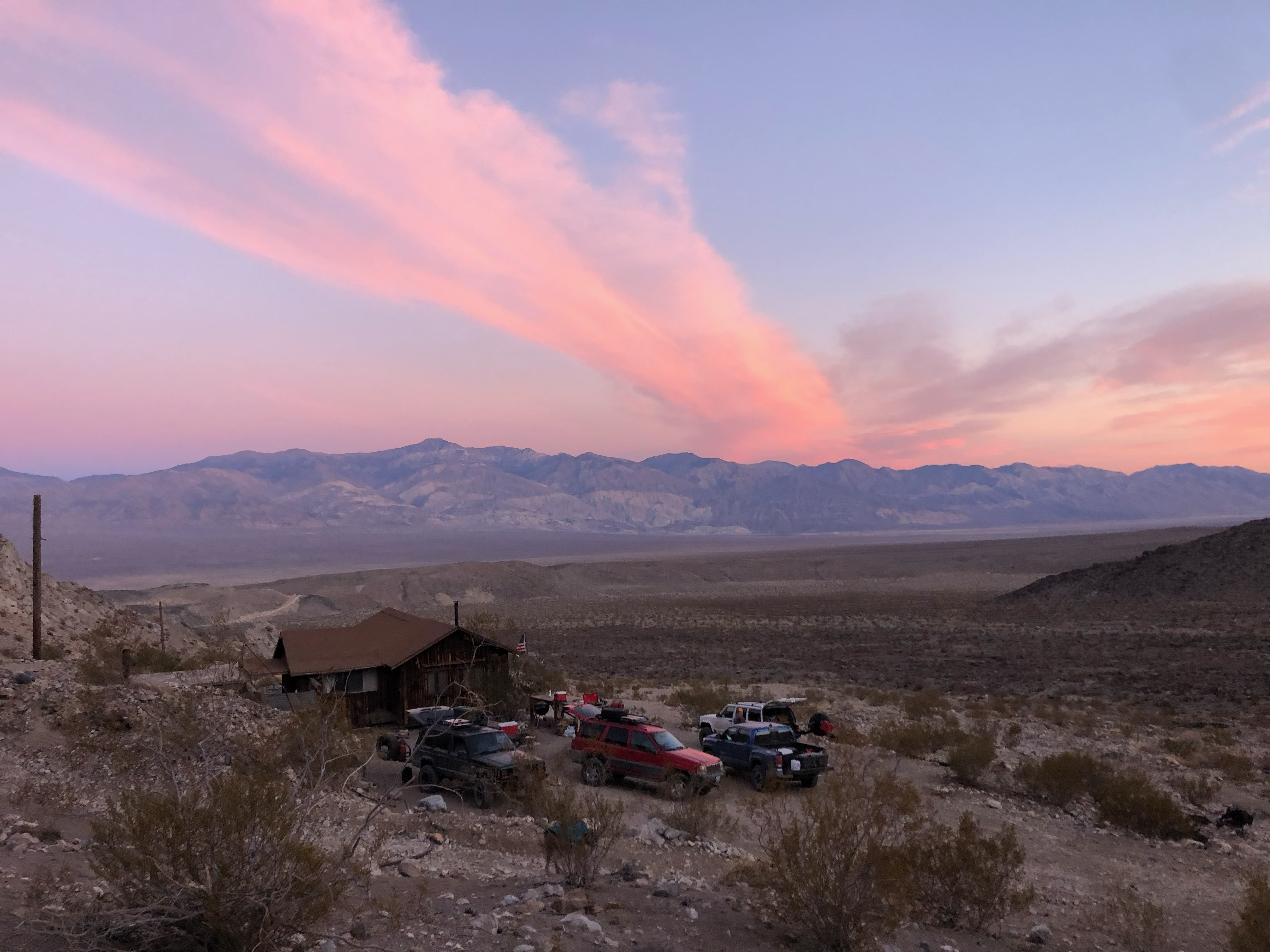 A beautiful read sunset over the mountains in the background.
