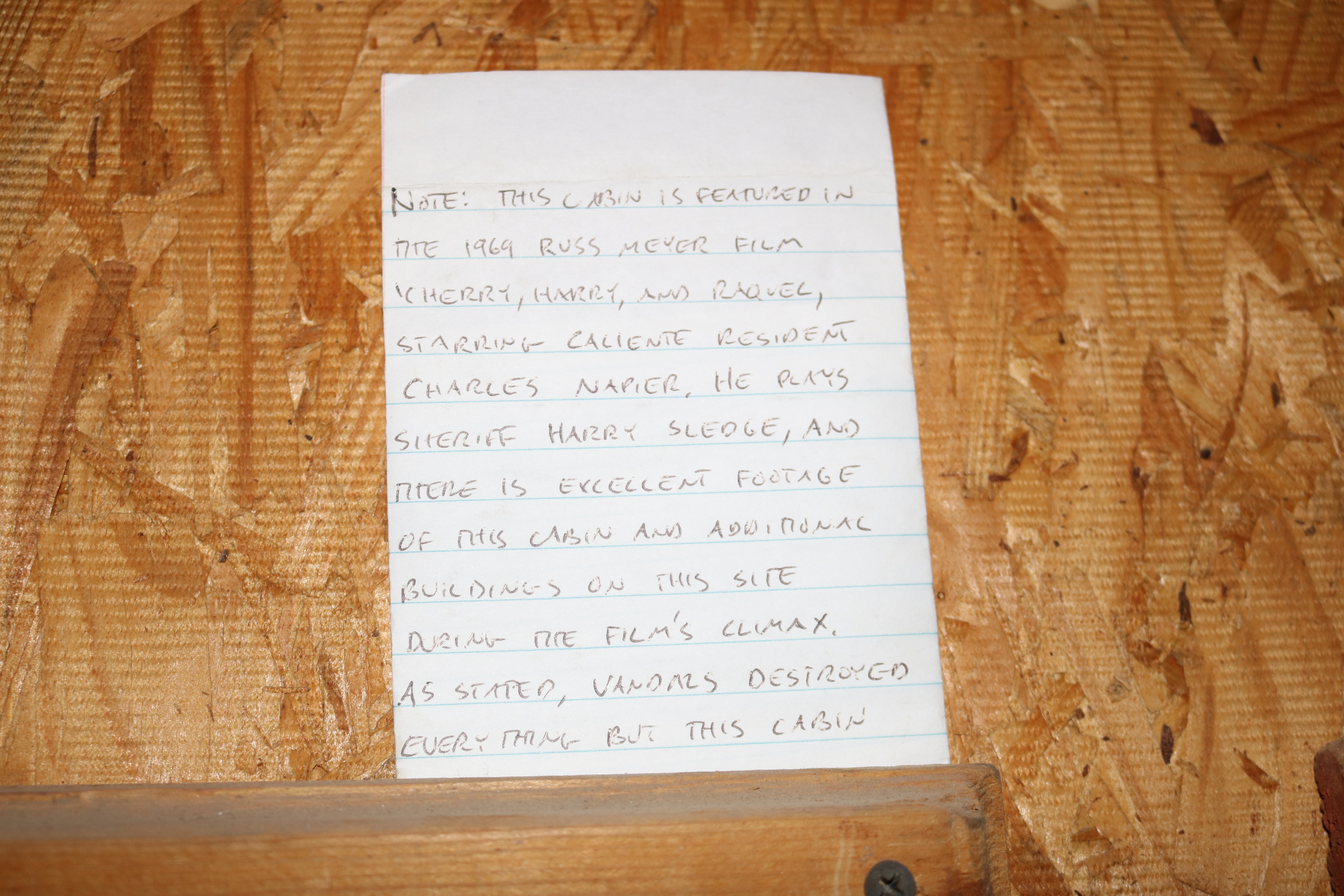 Flyers/photos/articles framed on a wall.