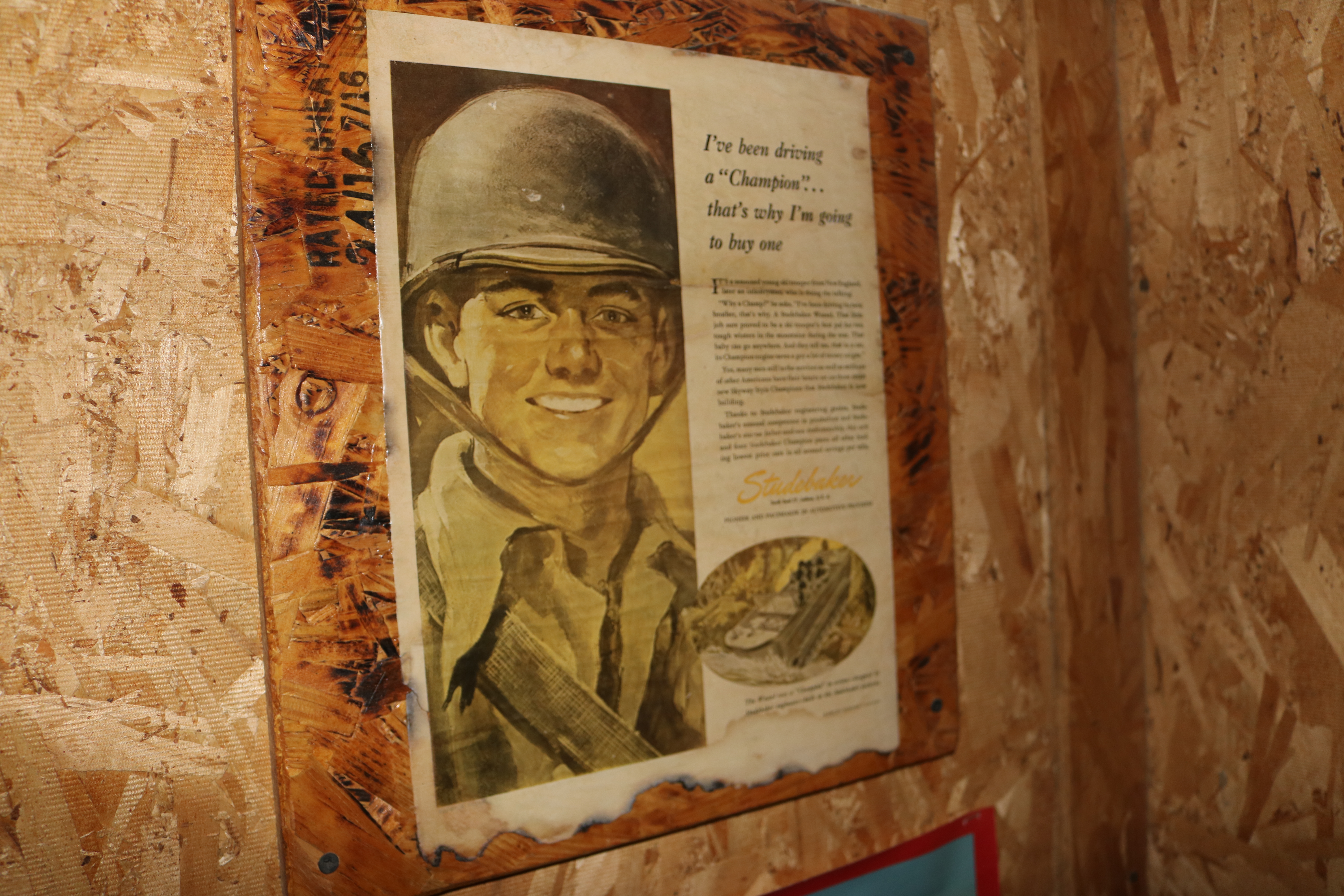 Flyers/photos/articles framed on a wall.